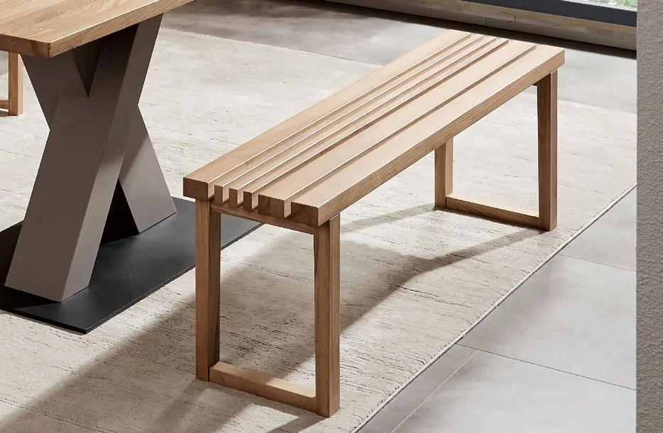 Solid wood end-of-bed bench with slatted seat, beside a dining table